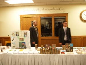 Seminary students Brian Feenstra and Nathan Price help at the Seminary display tables